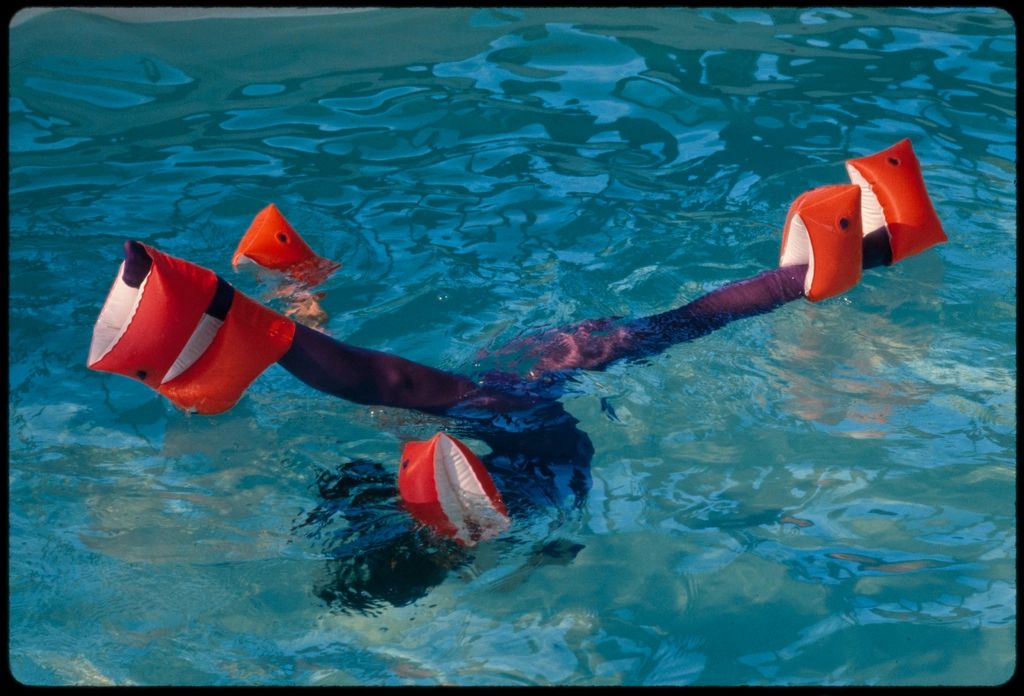 The outdoor swimming pool with loungers alongside