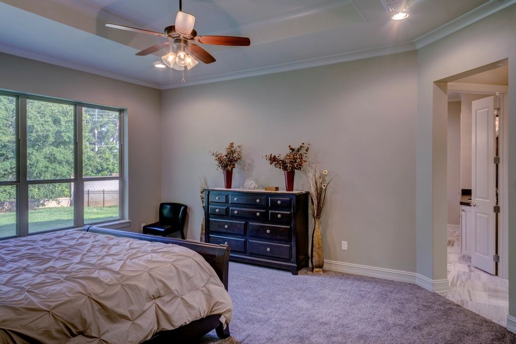 A guest room with a large bed and soft lighting